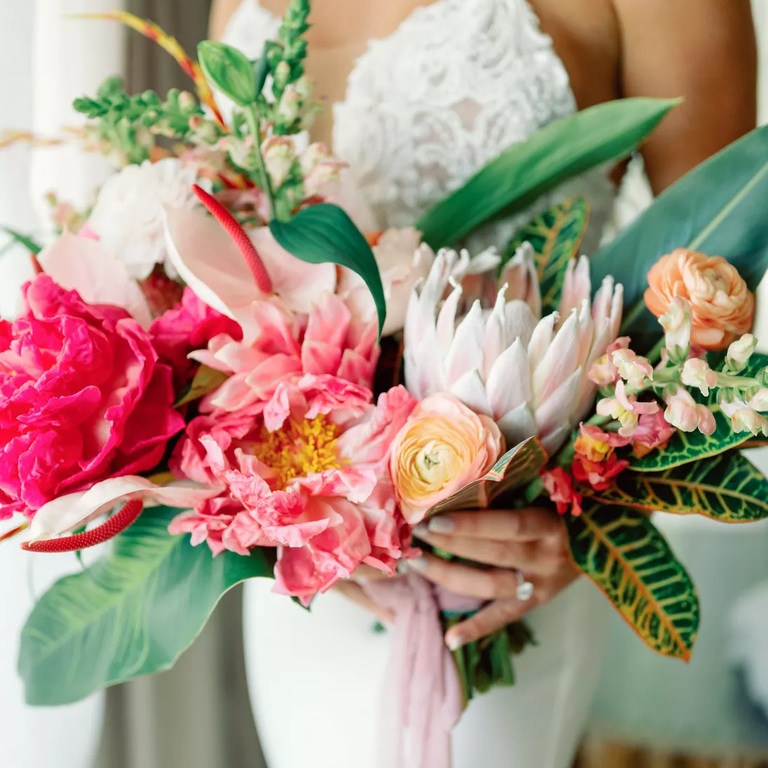 A pink and white protea and peony wedding bouquet
