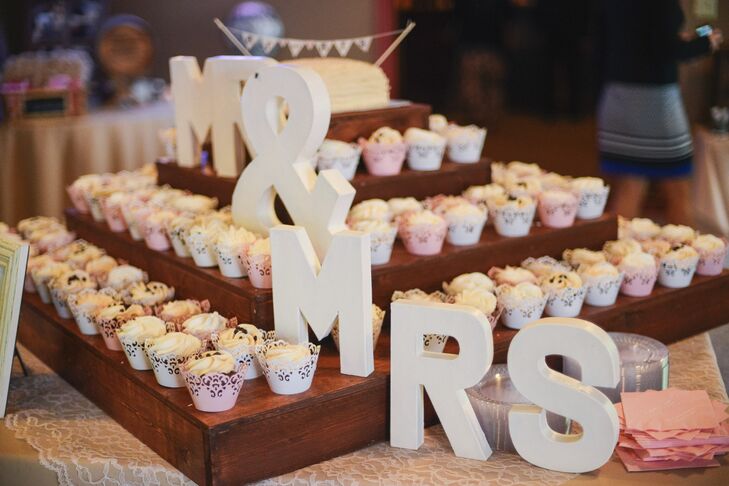 Cupcakes were arranged in a tower formation with large white letters that spelled out "Mr & Mrs."