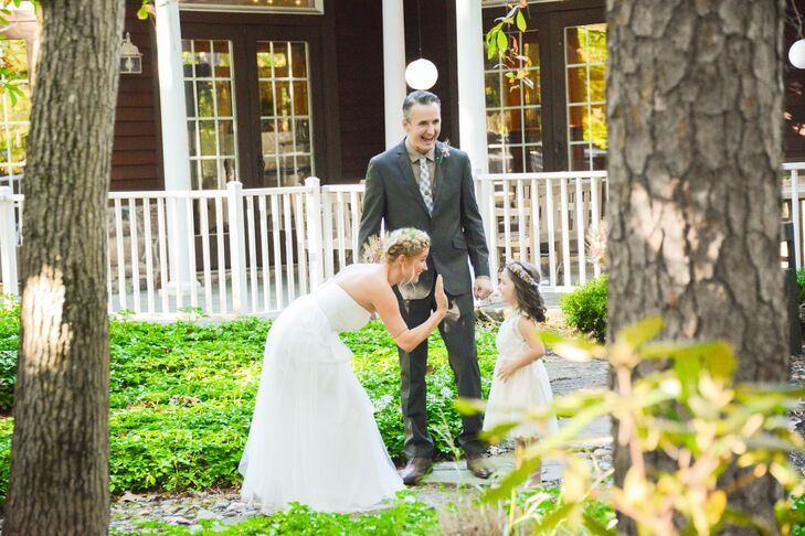 After dating for 12 years, Stephanie, Michael and their daughter, Izzie, celebrated the couple’s marriage with a few moments alone. Delaney Dobson Photography captured the trio as they shared a high-five and a few laughs alongside the Lakeside Clubhouse Wedding & Reception Facility in Medford, New Jersey.