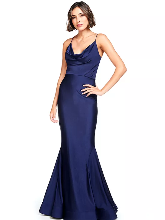 A model shows off a navy blue dress with a cowl neckline and mermaid flare.