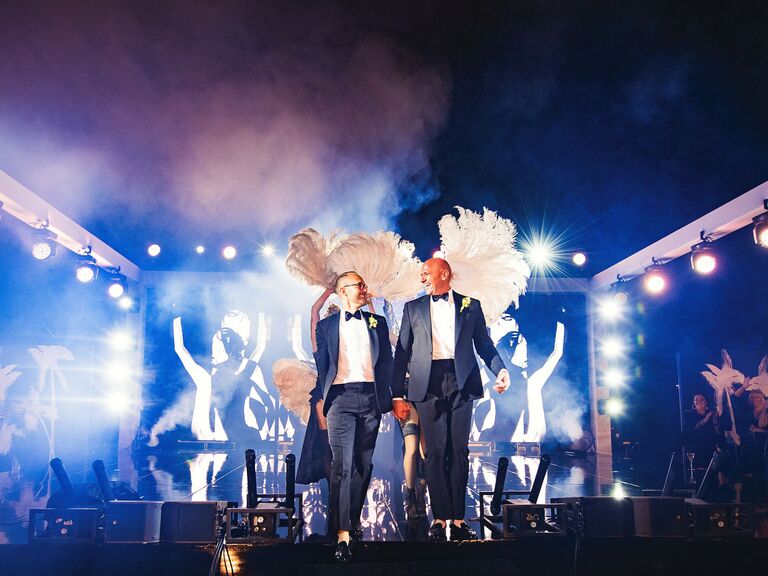 Couple holding hands on stage