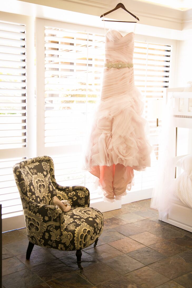 “I saw the dress in a magazine even before our engagement, and it was a dress that caught my eye because it was pink and a bit different than anything I had seen before (Ginger by Kitty Chen,)” says Kelli. “Everyone who knows me would tell you I love all things pink, and the dress was a very elegant spin on pink. I wore a long pink veil crafted by Mia Bella Couture (where the dress was purchased) in Fresno, California, as well as a rhinestone belt and matching Badgley Mischka shoes.”