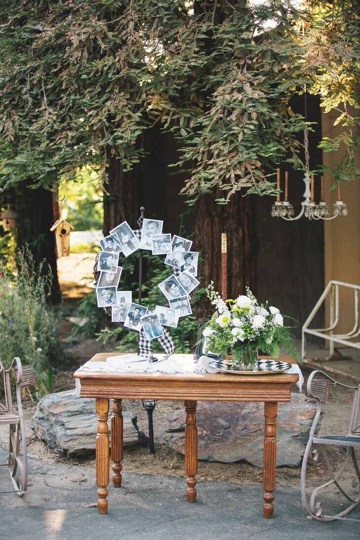 At the reception, a photo collage was displayed in the shape of a wreath, displaying old family photos. On the same table, there was a lush ivory and green flower arrangement.