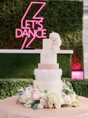 Neon Sign Behind Pink-and-White Wedding Cake