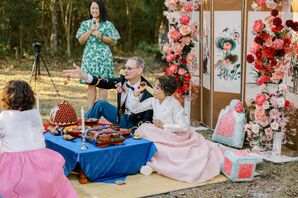 Father in Military Formalwear and Mother in Korean Dress Throwing Dates, Chestnuts During Paebaek Ceremony