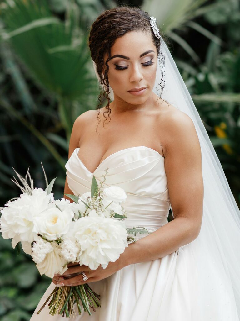 natural wedding hairstyle low bun with pieces out front