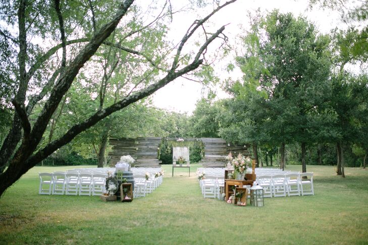 Tylar and Erick's wooden wedding arch, surrounded by trees and green grounds, helped set theme and ambience she envisioned for their outdoor wedding. String lights enhanced the soft, romantic ambience.
