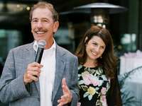 Man holding microphone next to woman 