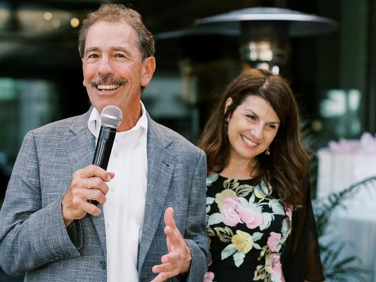 Man holding microphone next to woman 