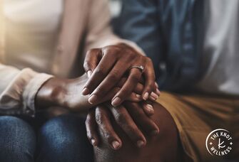 Close-up of couple interlocking hands 