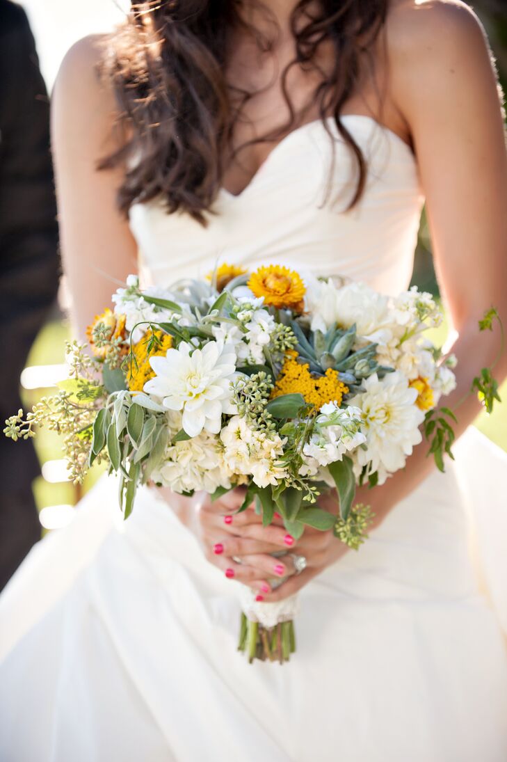 The bride carried a yellow, green and white bouquet. The main flowers were yellow straw flowers, green succulents and white dahlias to create a rustic but modern feel.