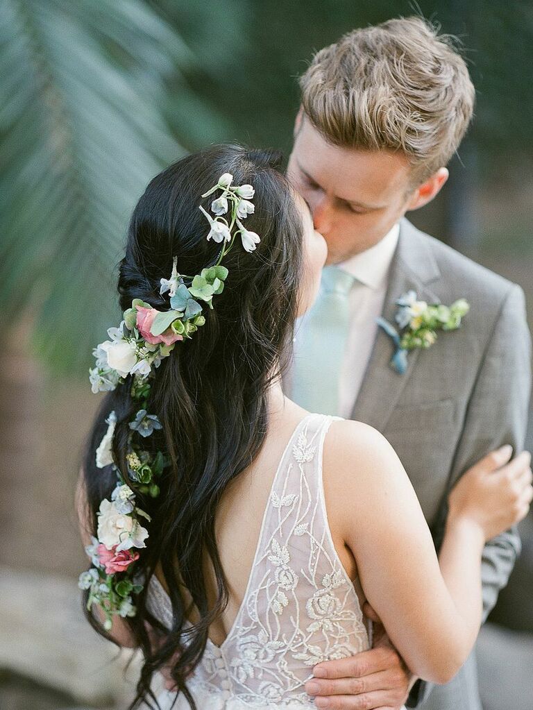 wedding hair flowers braided half up with greenery woven in