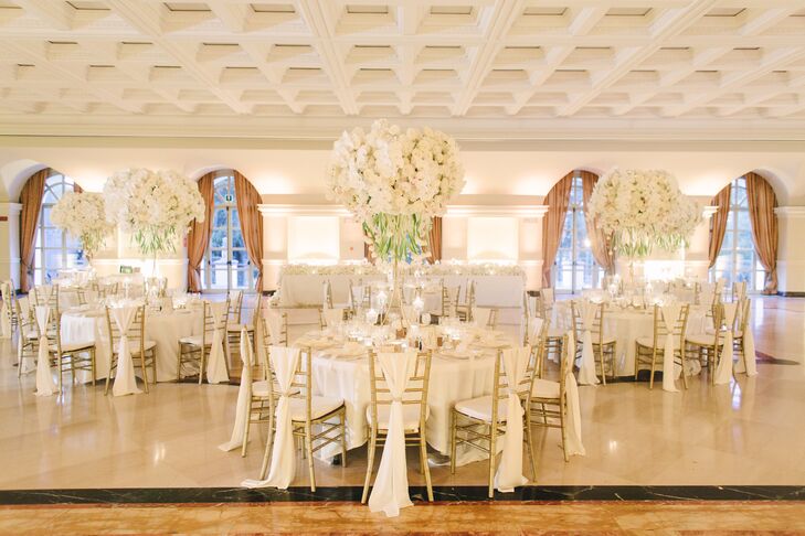 While Silje and Tommy originally hoped for an alfresco reception, unpredictable fall weather led the pair to host the postceremony festivities indoors. This proved to be no compromise, however; its elegant old-world feel provided a striking spot for dinner and dancing. To achieve their luxe, glamorous vision, the couple filled the charming space with panels of ivory silk, gold-rimmed dinnerware, ornate arrangements of white roses and orchids, and plenty of romantic candlelight.