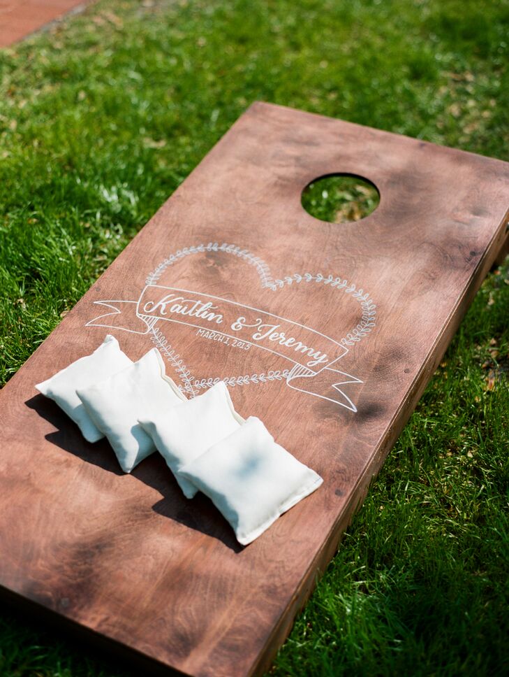 Lawn games added a fun element to the reception at Cross Creek Ranch in Dover, Florida, including cornhole with custom boards and beanbags and horseshoes in the wedding colors.