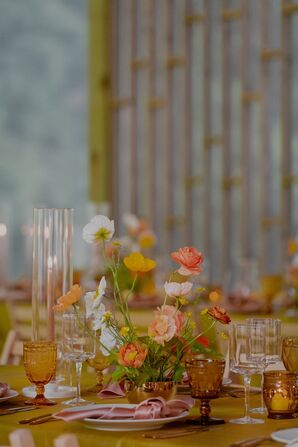 Low and Colorful Centerpiece of Wildflowers and Candles at Vintage Reception