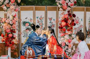 Bride and Groom in Traditional Korean Attire at Paebaek Ceremony Sharing Customary Tea