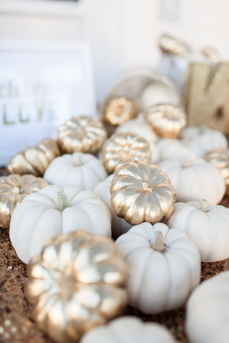 Since the wedding was held in October, Kendal wanted to incorporate some fall themed decor. She had about 60 miniature pumpkins which she painted shiny gold and used those on the welcome table, guest book table and bar. It was a great way to tie the season into the color palette.