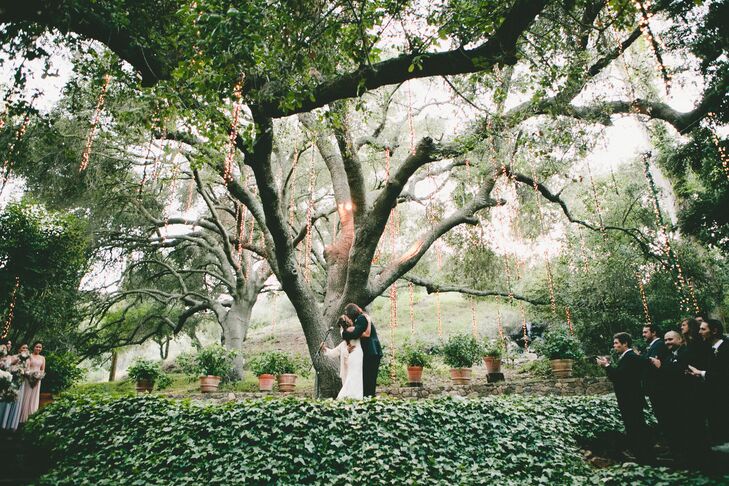 Marisa and Kyle got married outside Calamigos Ranch in Malibu, California, where they stood under a grand 100-year-old oak tree. An elevated platform with the front covered in green ivy allowed all friends and family to have a great view of the ceremony, no matter where they sat.