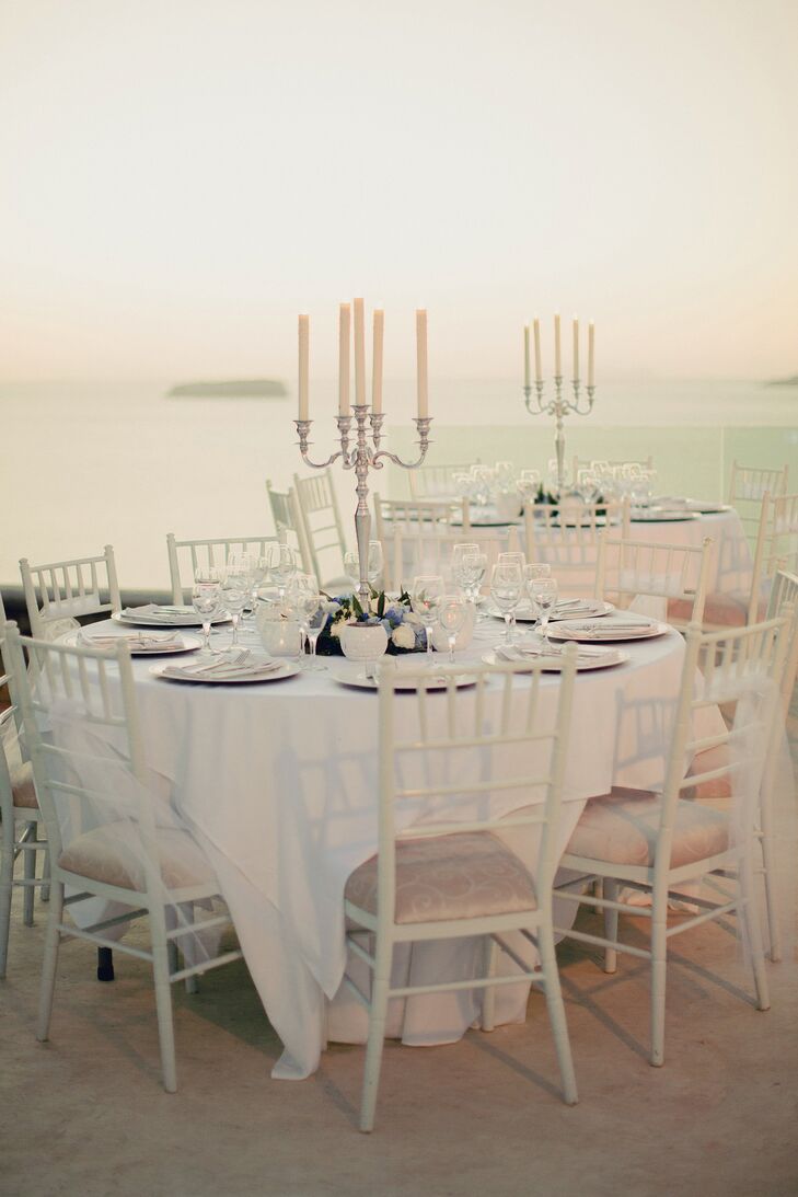 Candlesticks surrounded by blue and white flowers adorned the reception tables for the guests.