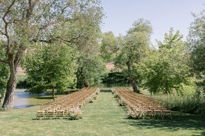 Outdoor Ceremony on Lawn With Pastel Flowers Next to Pond