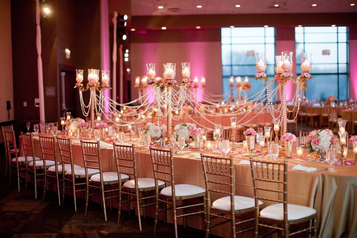 Megha and Hari’s reception was all about glamour and romance. To bring their vision to life, Oliveaire created stunning centerpieces with gilded candelabras dripping with crystal garlands and pale pink tea roses. Tea lights illuminated each table and worked perfectly with the magenta uplighting to give the ballroom a warm, ambient glow.