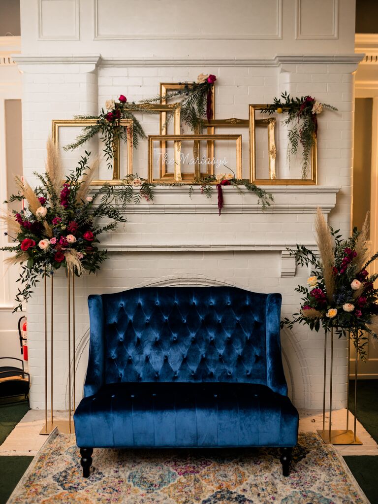boho wedding fireplace decor idea with mismatched rectangular gold picture frames 