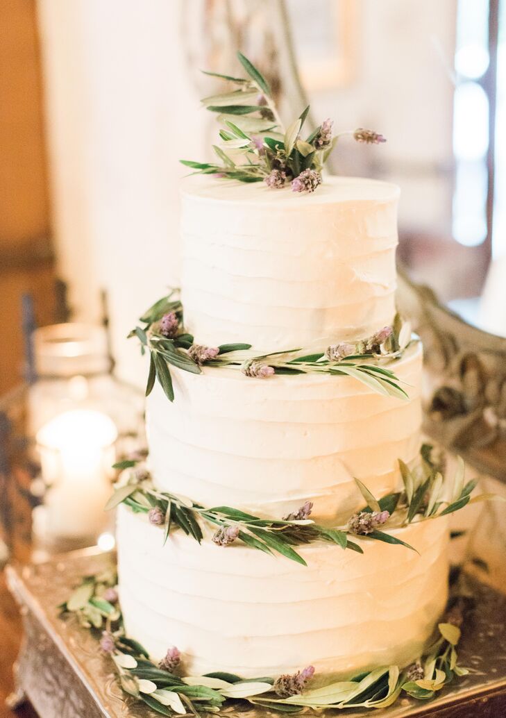 The three-tier wedding cake covered in cream-cheese icing had leaves rimmed around the base of each layer, in addition to decorating the top. The cake was filled with lemon, banana and carrot-cake flavors.