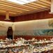 Indoor Reception With Mural, Long Wood Tables, Wood Chairs With Minimalistic, Low Centerpieces