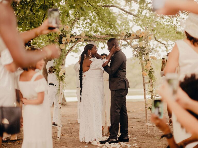 Boho yellow floral wedding arch at outdoor park wedding