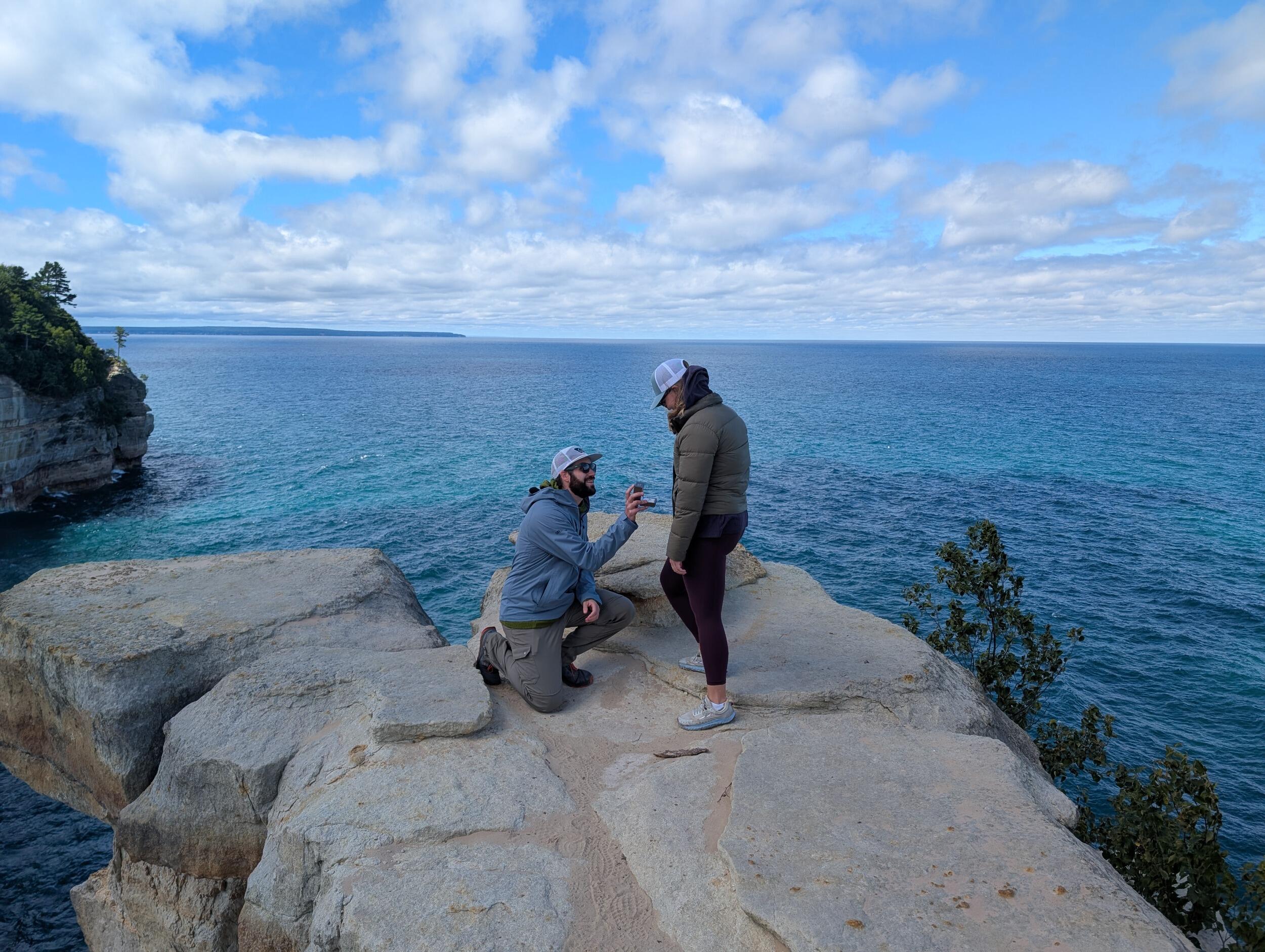 At their favorite spot in Michigan, Ben got down on one knee and said, ‘I always pictured putting a rock on your finger at Pictured Rocks.’