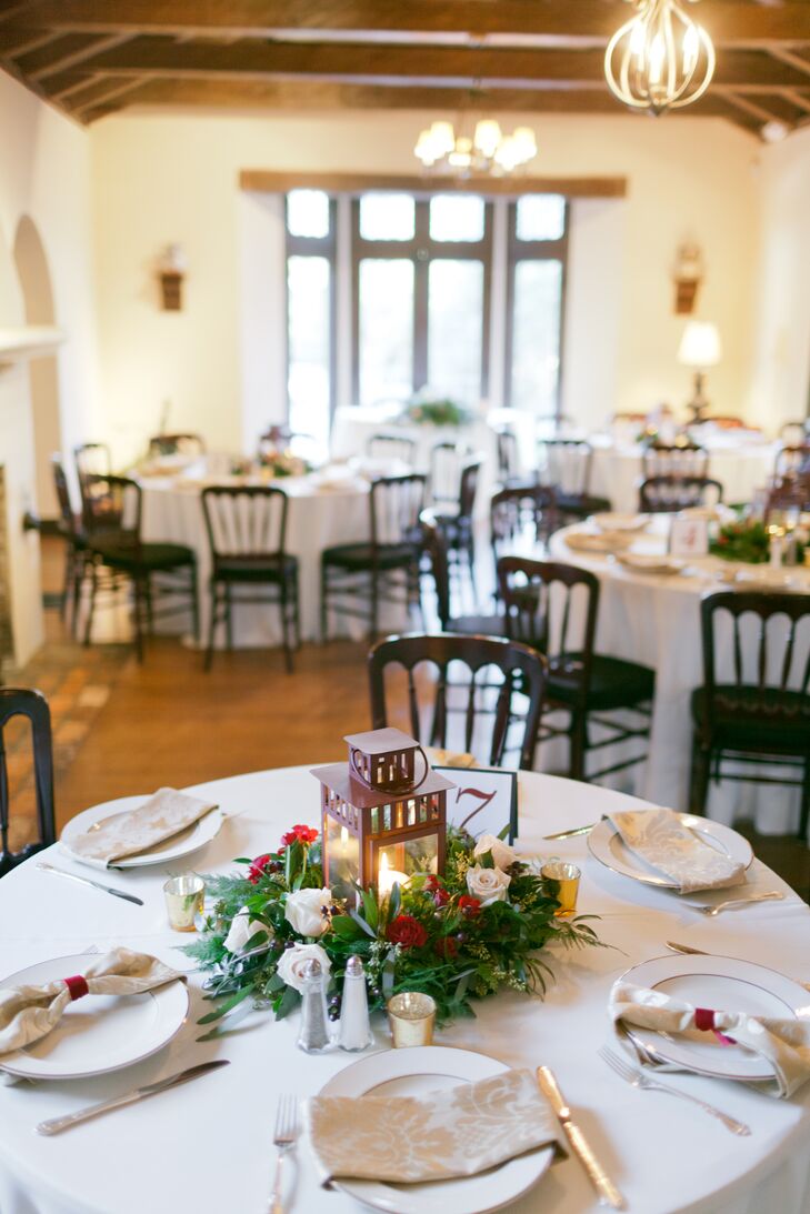 Windermere Flowers and Gifts incorporated Casa Feliz's lush greenery into the wedding with each natural centerpiece. Rustic, copper lanterns were accented with a halo of red garden roses, white roses and greenery as candlelight added a soft glow from within.