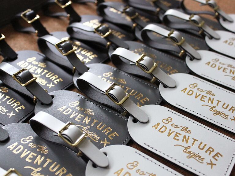 Dark and light gray luggage tags with gold text and small airplane graphic