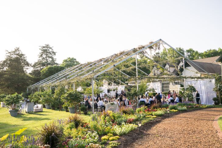 A tent frame was set up for the outdoor reception but was draped with smilax and tree ivy. Comfortable seating areas were placed around the tent with lanterns for mood lighting as the sun went down.