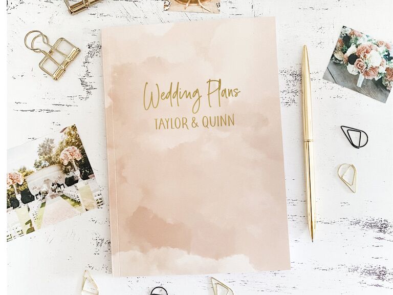 Gender-neutral wedding planner book with pink watercolor cover