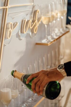 Champagne Pouring into Flutes on Champagne Wall at Luxurious Wedding