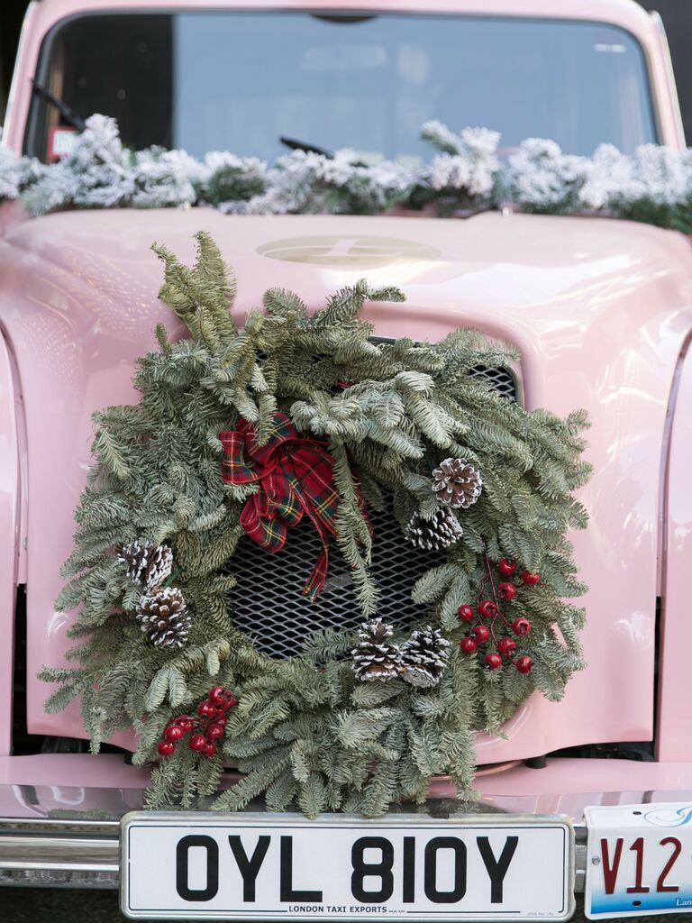 vintage pink cab decorated with greenery wreath on the hood