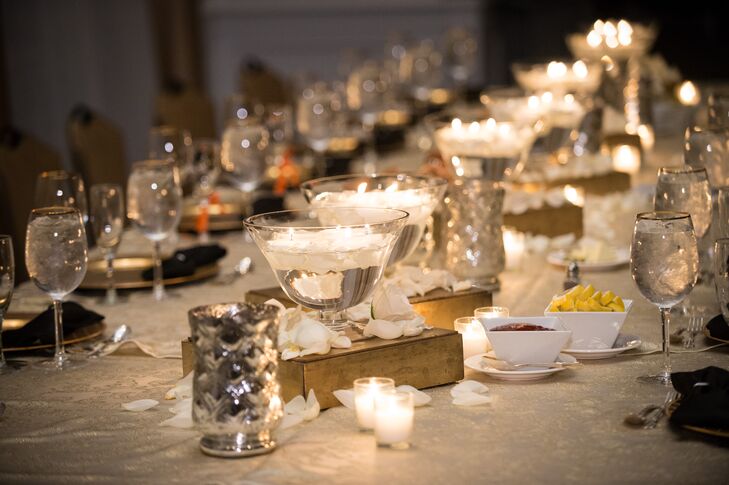 The head table was scattered with bowls of floating flowers and floating candles. Alongside these were tea candles and silver chargers. All around the room there were hundreds of candles used to set a romantic mood.