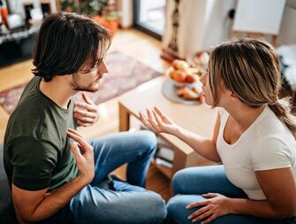 Couple sitting on a couch having an argument