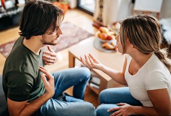 Couple sitting on a couch having an argument
