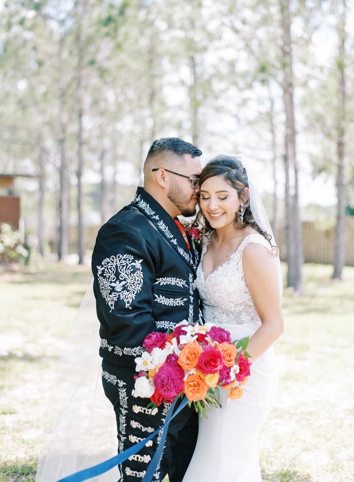 Groom in Mexican-Inspired Suit Hugging Bride