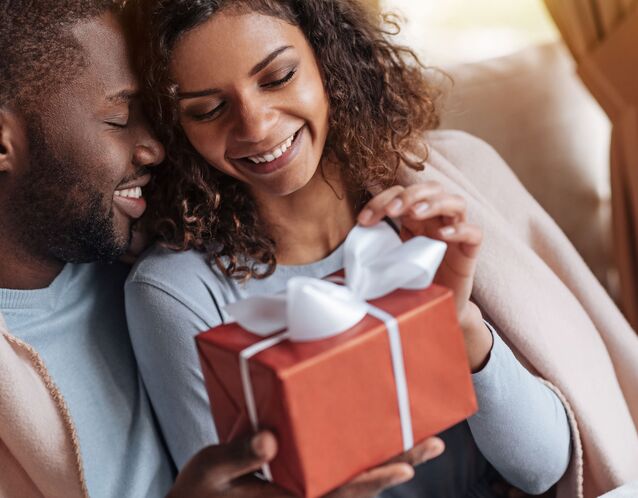 Couple opening anniversary gift for marriage milestone