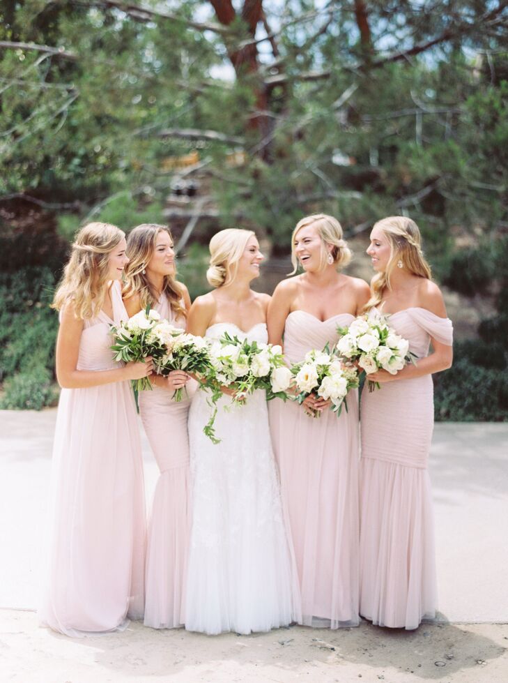"I decided to keep my bridal party to my four sisters," says Anne. "I wanted the bridesmaids’ bouquets to include pops of blush, but mimic my own bouquet."