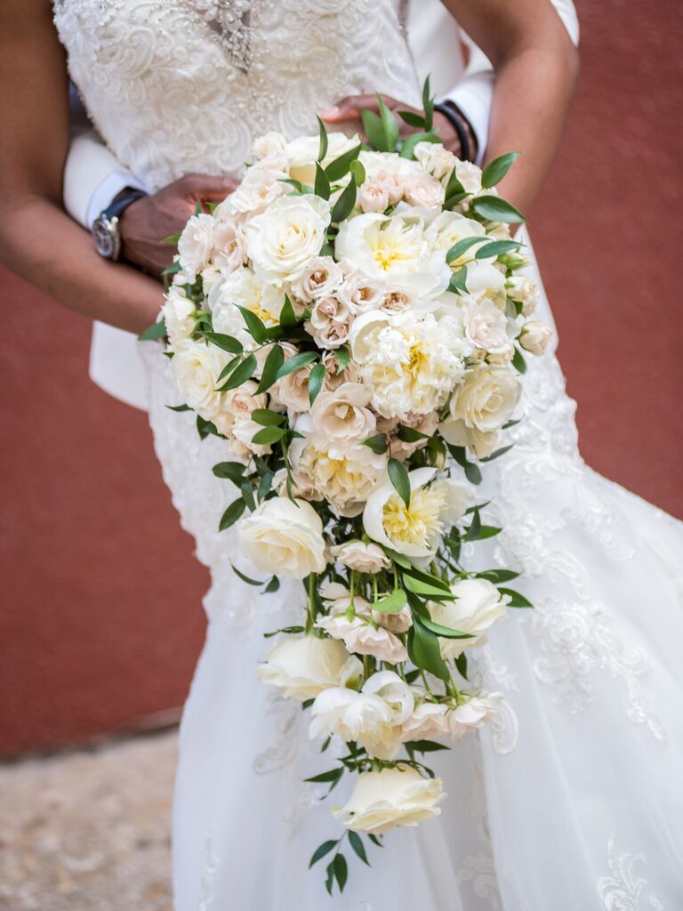classic cascade bridal bouquet with white peonies, garden roses and greenery vines