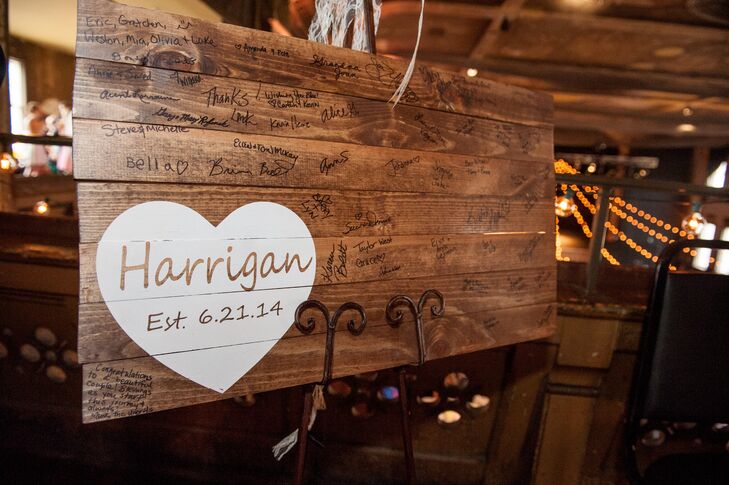 In keeping with the rustic elements of the decor, Amber and Andy's guest book was a wooden sign guests could write on.