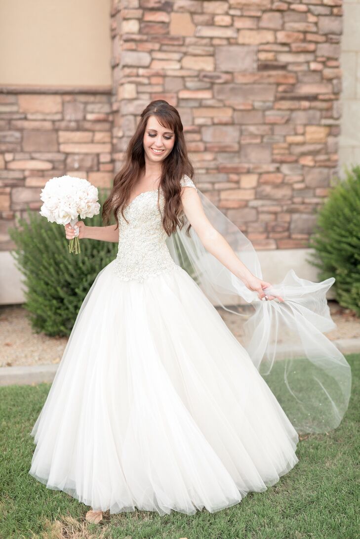 Brittney wore a stunning Kenneth Winston ball gown dress with a hand-beaded bodice that sparkled with crystals. "It was the first dress I ever tried on, much like my husband: He was my first kiss and my first boyfriend," she says.