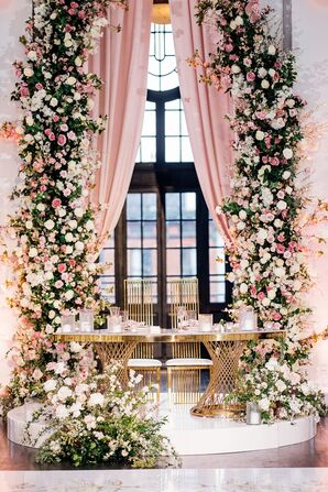 Sweetheart Table With Towering Flowers in Shades of Pink for Fairytale Reception