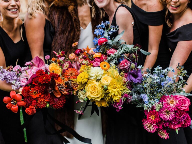 Bridesmaids hold a rainbow of colorful bouquets.