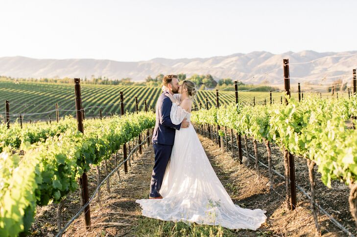 Bride and Groom Kiss in Vineyard During Golden Hour