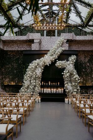 Elegant Ceremony Altar With Asymmetrical White Floral Structure Backdrop, Candles, Greenery