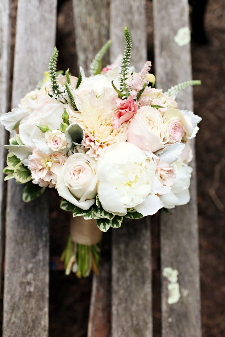 Aimee's bridal bouquet was a hand-tied arrangement of peonies, ranunculus, garden roses, dahlias, spray roses and dusty miller all wrapped with burlap ribbon.